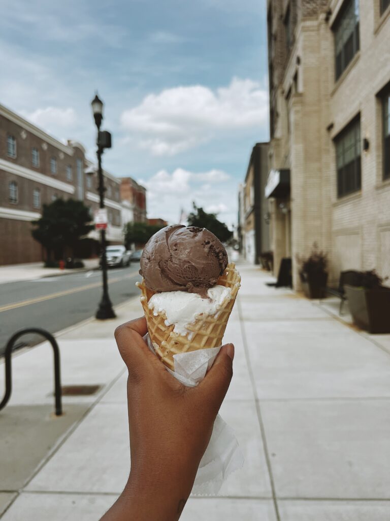 Ice cream cone with two scoops of ice cream. Chocolate and Vanilla on a hot summer day
