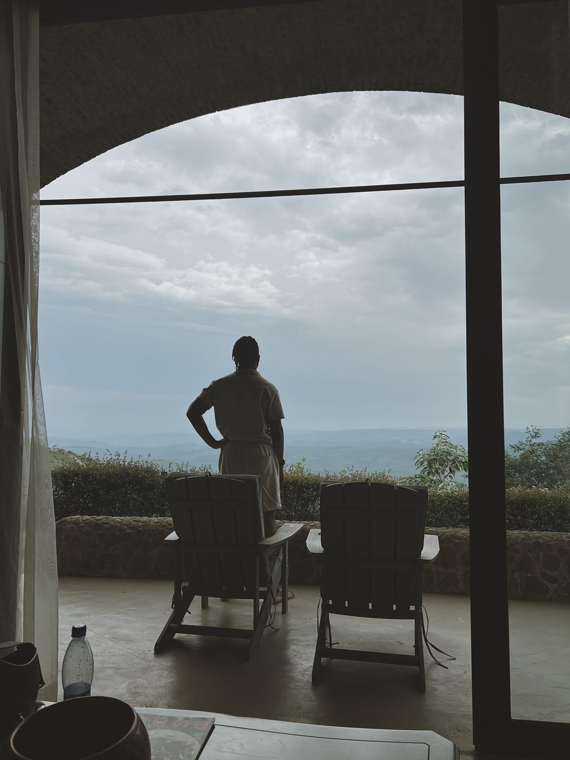 Man standing in front of the Grotto Suite, watching the sun set at the Angel's View Hotel, Mpumalanga