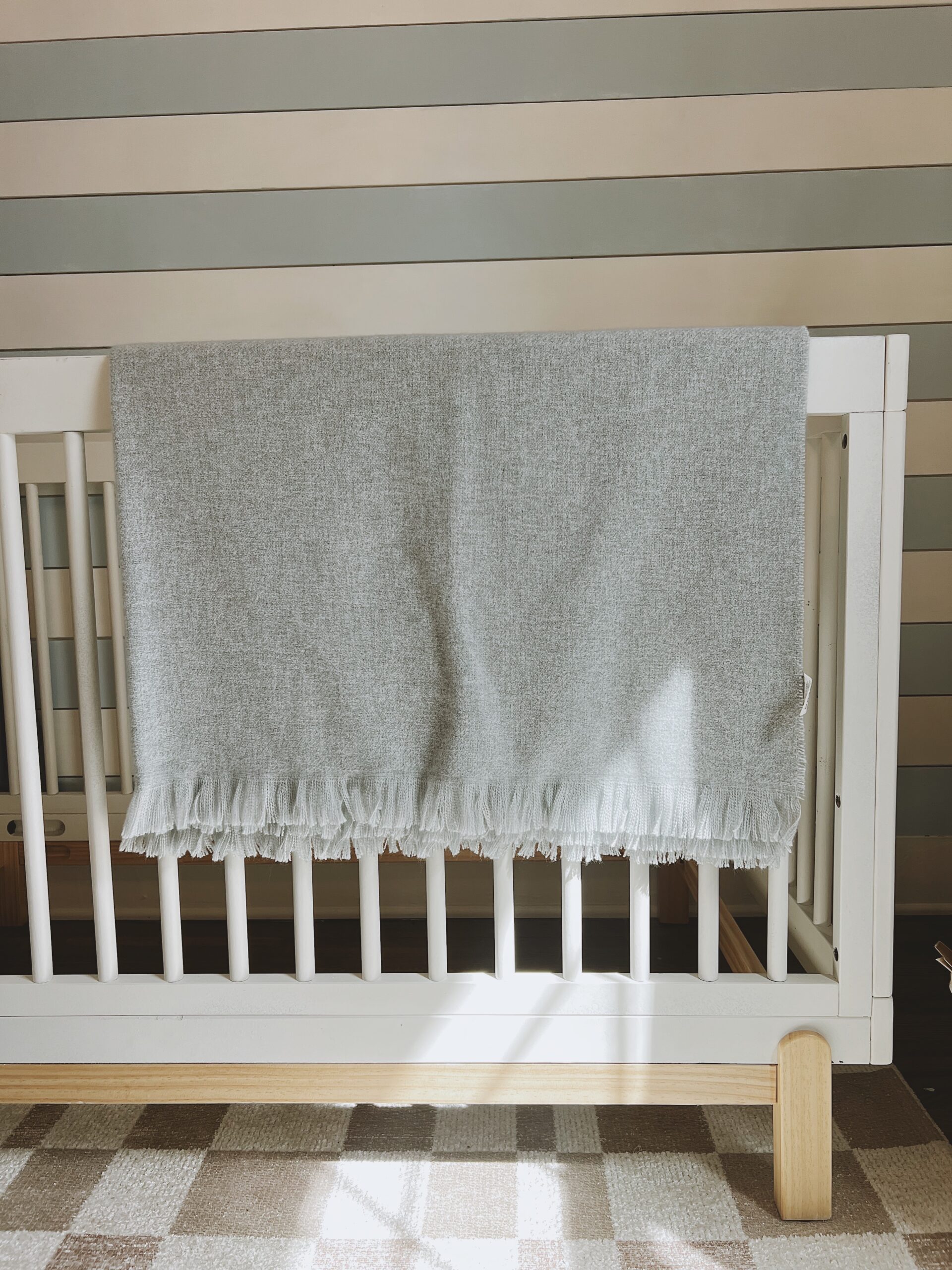 Baby's crib with light blue blanket