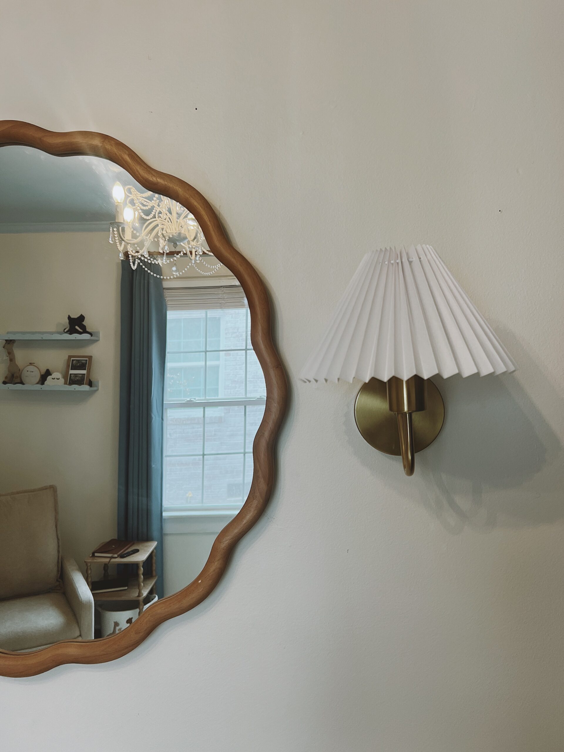 Boy's nursery. Round mirror and sconces on the side.