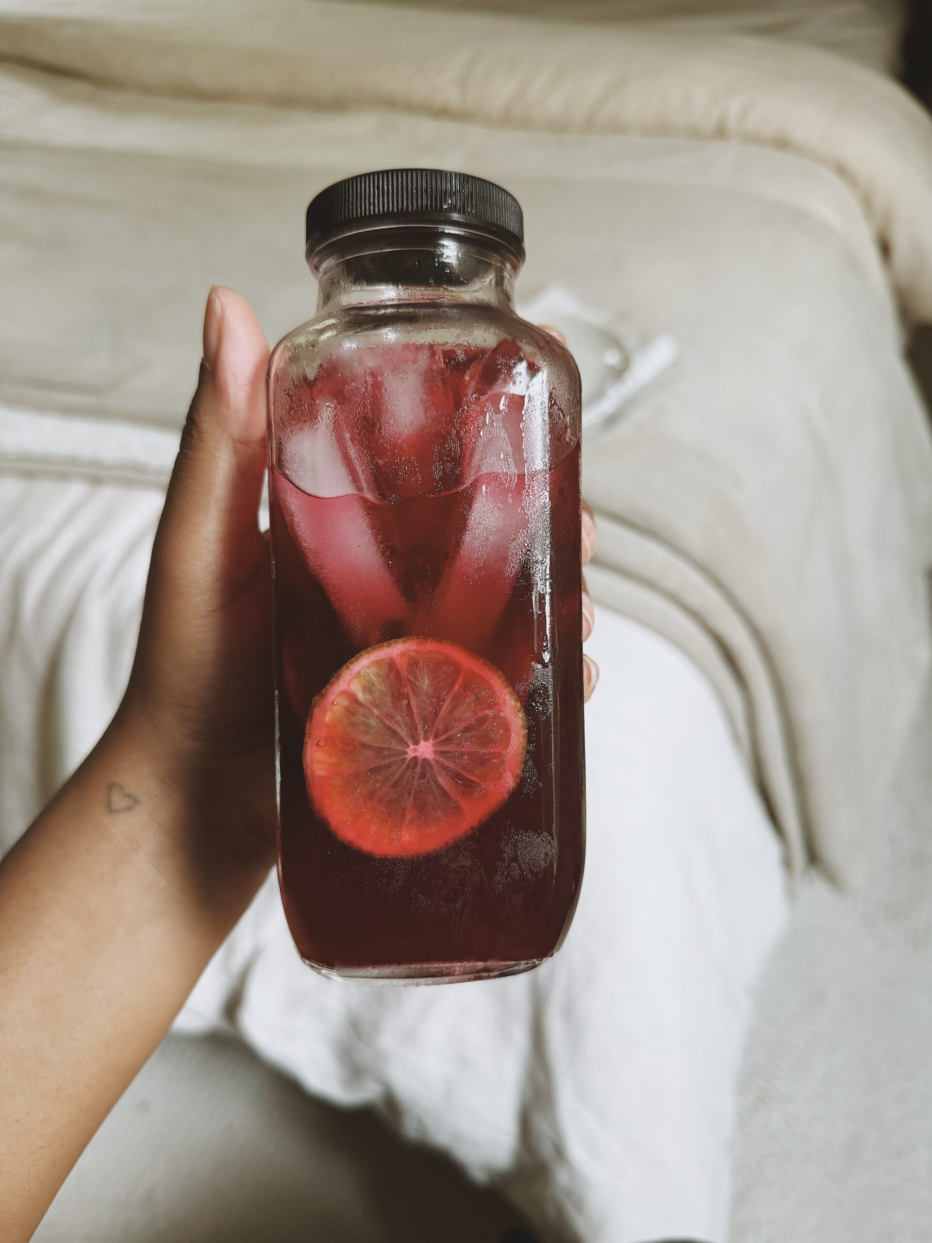 Raspberry leaf and hibiscus tea in a jar