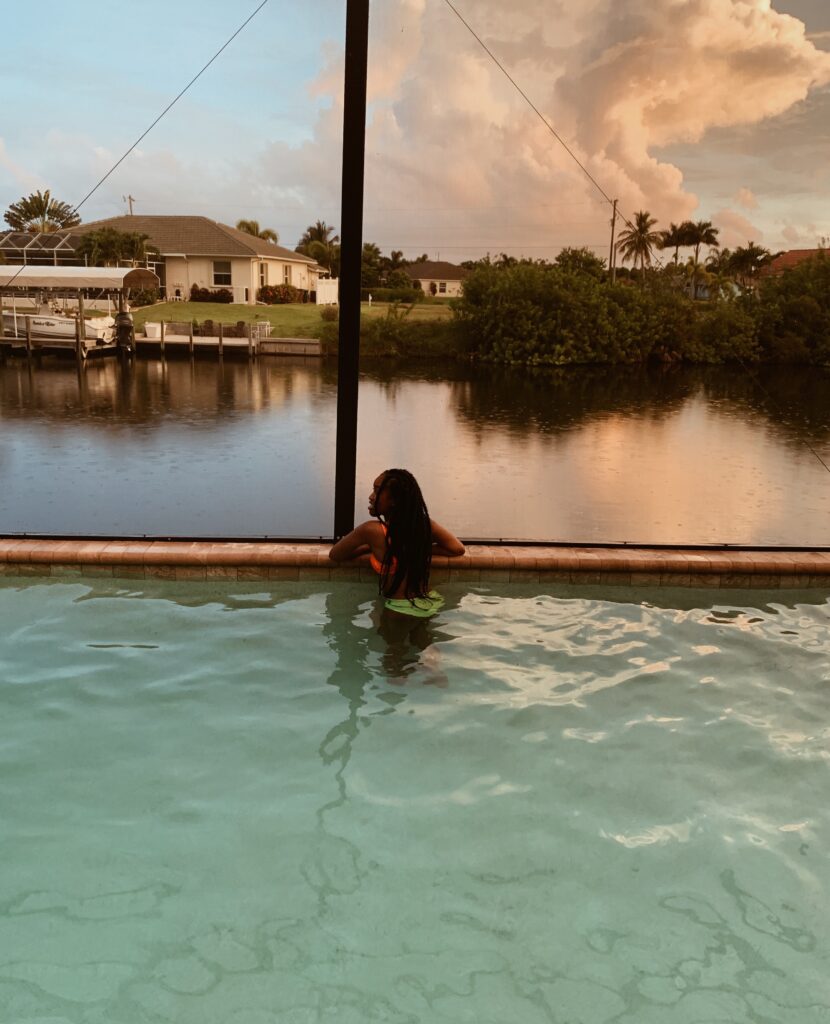 Woman in a swimming pool overlooking the river