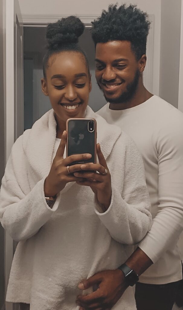 A couple taking a mirror picture together, looking happy in love