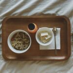 Chicken Noodle Soup in a bowl with crackers served on a tray