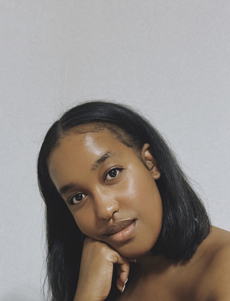 Black woman with straight natural hair, silk pressed.