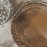 A baked sweet potato pie on a wooden board