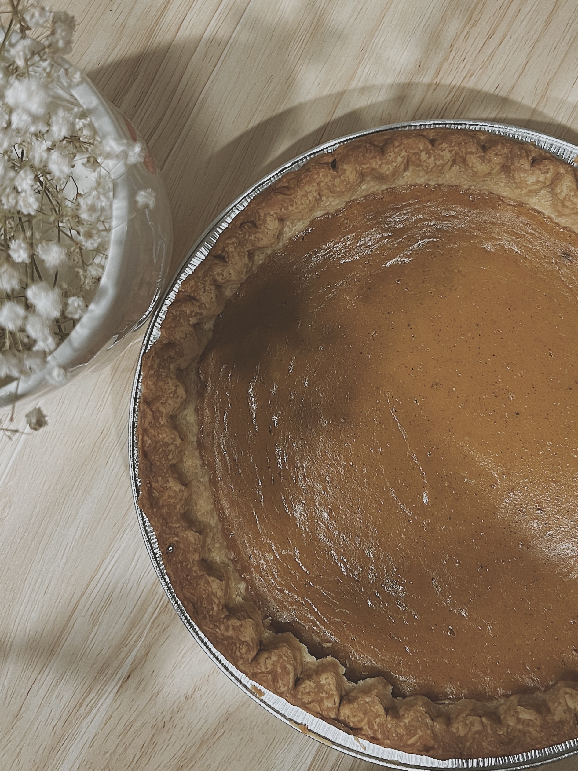 A baked sweet potato pie on a wooden board