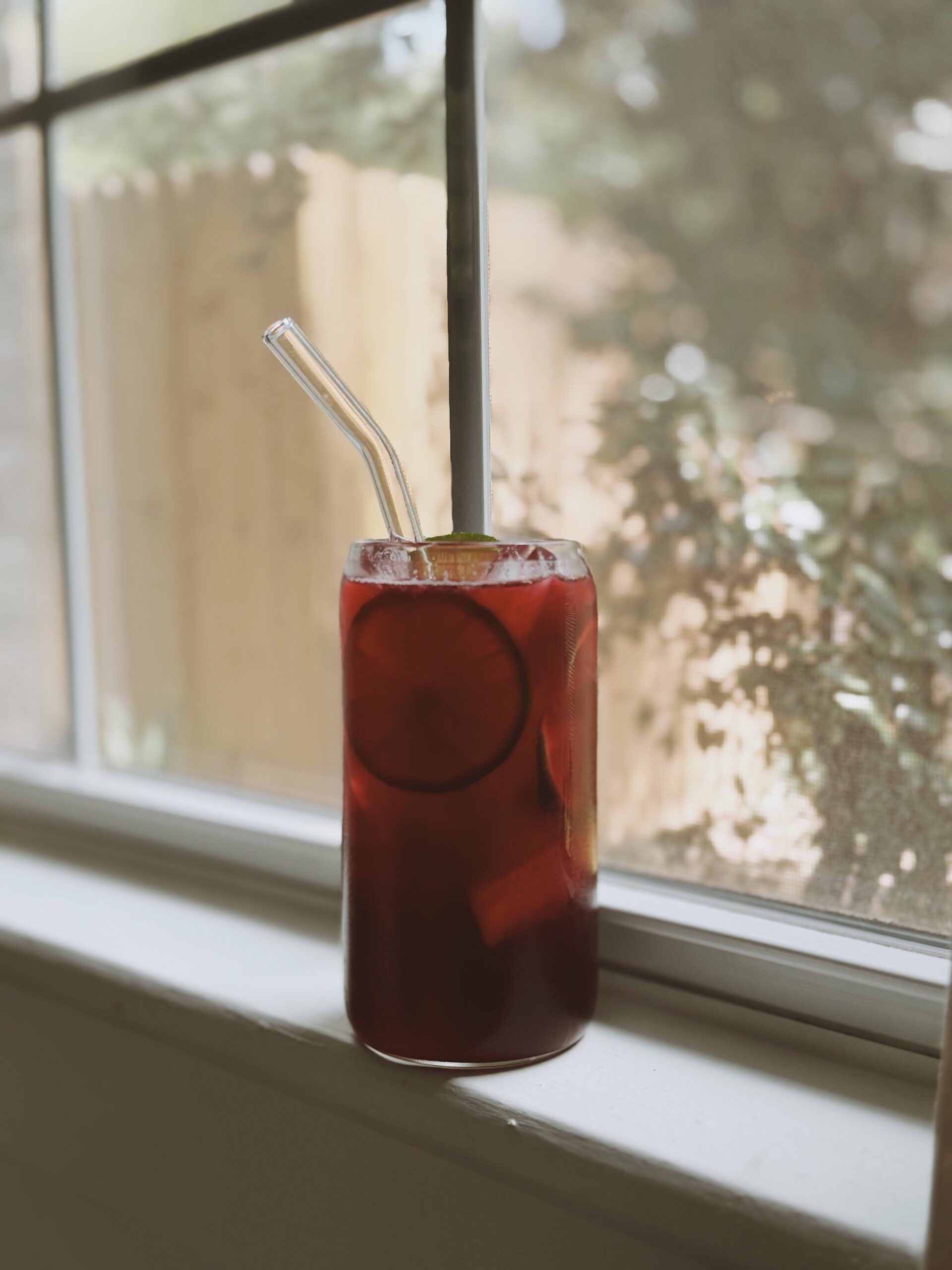 Raspberry leaf tea for period cramps in a glass, displayed by the window